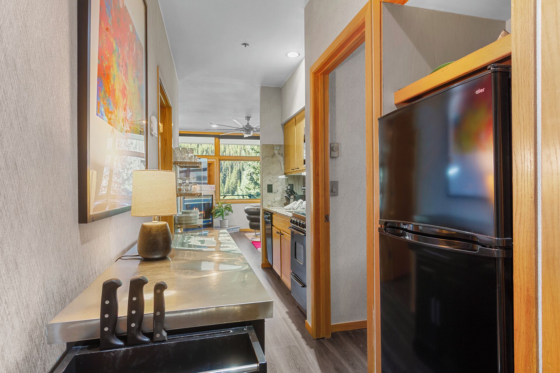 A modern kitchen with a refrigerator, stove, and sink.