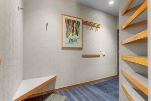 A hotel room with a wooden staircase, a framed artwork on the wall, and a small table. - Condo in River Run Village! Fireplace! 5 Minute Walk to the Ski Lift! (Keystone)