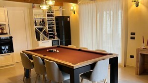 A modern living room with a pool table, comfortable seating, and a cozy fireplace. - A beautiful guesthouse where you can relax and enjoy some quality time. (Lanzara)