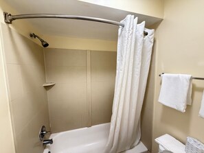 Bathtub, towels, soap, shampoo