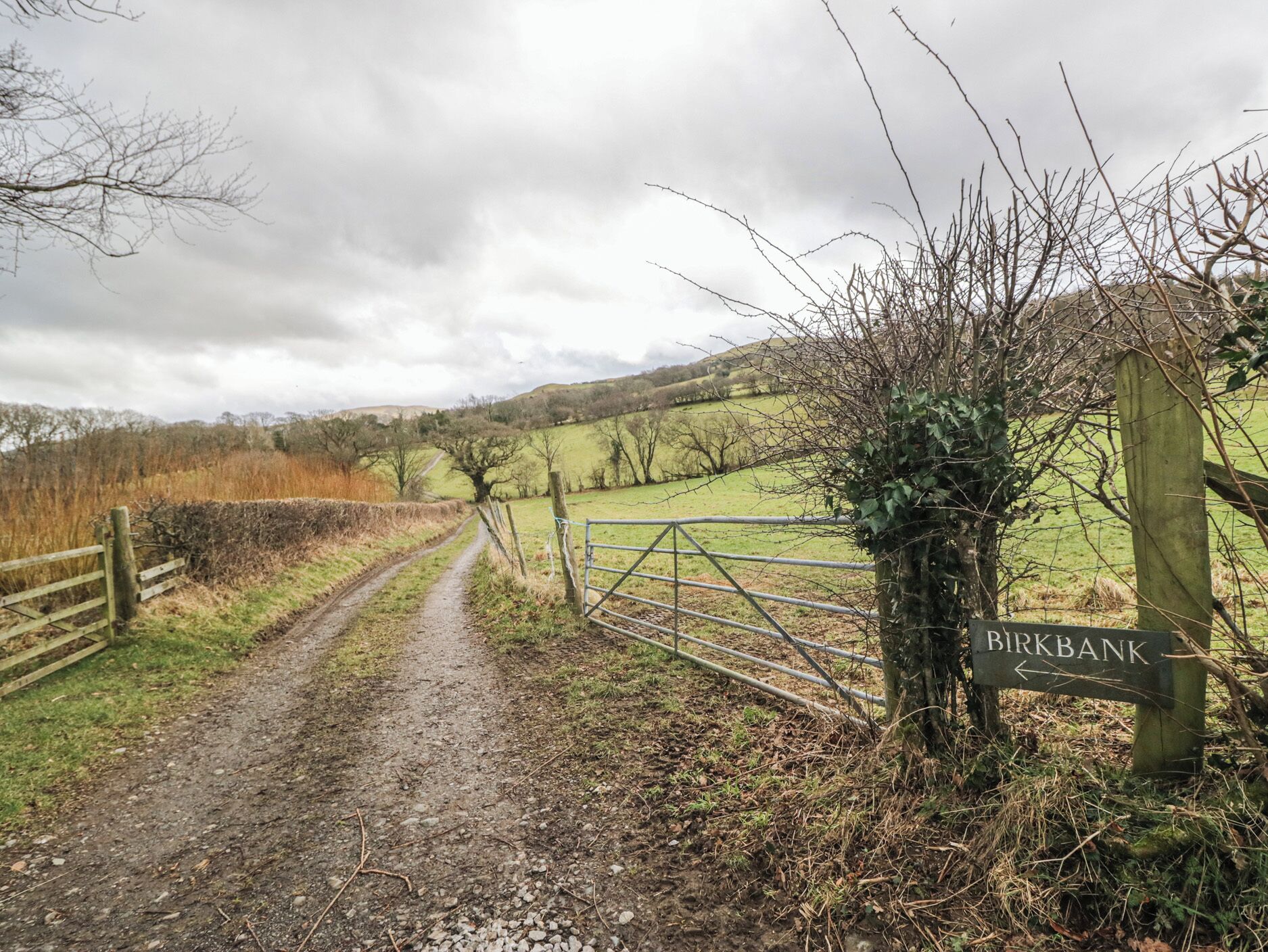 Un sentier rural menant à une porte sur laquelle est apposée une pancarte indiquant « BIRKBANK ».