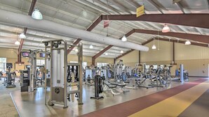 Ein großzügiger Fitnessraum mit verschiedenen Trainingsgeräten und -ausstattung.