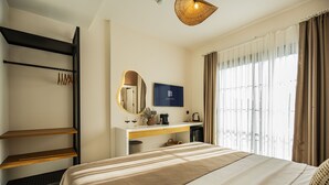 A hotel room with a bed, a desk with a mirror, a flat-screen TV, and a window with curtains. - Lyse Jülide (Cesme)