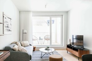 Een moderne woonkamer met een bank, salontafel en tv-meubel.