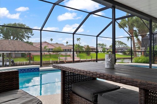 Waterfront Retreat with Pool BBQ and Canal Views