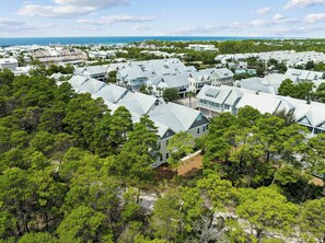 A coastal residential area with multiple houses, dense greenery, and a clear view of the ocean. - Fitness Facility | Pool Access | Garage (Panama City)