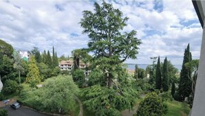 A residential area with trees, a road, and buildings. - Jewel on Lake Garda in Garda with Lake View (Garda)
