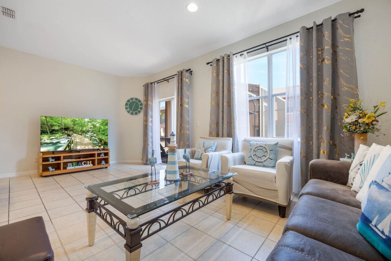A living room with a sofa, a coffee table, a TV, and a bookshelf.
