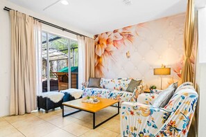 A living room with a sofa set, a coffee table, and a large window with curtains. - #2639 Mario Jacuzzi Pool @ Disney Epic & Universal (Kissimmee)