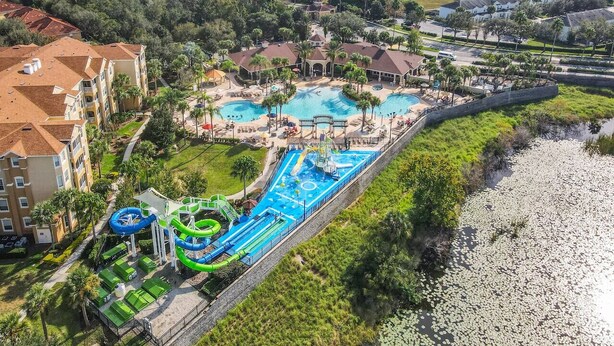 An aerial view of a resort with multiple swimming pools, a water park, and a beachfront area. - #304 Resort 3BR/2BA Pool/Spa WindsorHill Disney (Kissimmee)