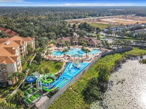 An aerial view of a resort with multiple swimming pools, a water park, and a beachfront area. - #304 Resort 3BR/2BA Pool/Spa WindsorHill Disney (Kissimmee)