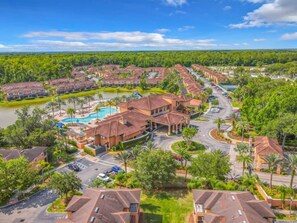 A resort with multiple buildings, a swimming pool, and a road. - #2701 Resort 2Master 4/3 Home Pool/Spa Disney Epic (Kissimmee)