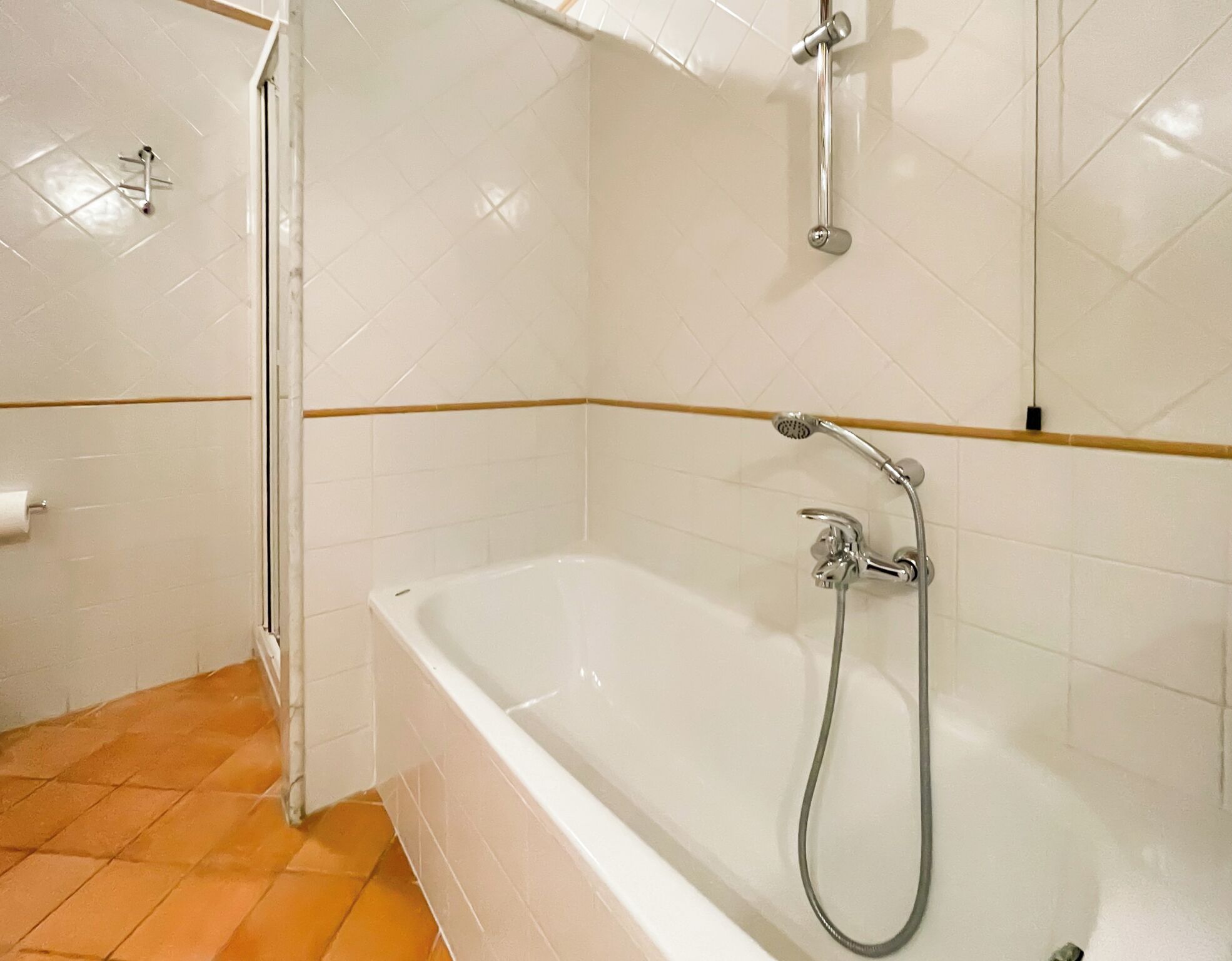 A bathroom with a bathtub, a shower, and a toilet.