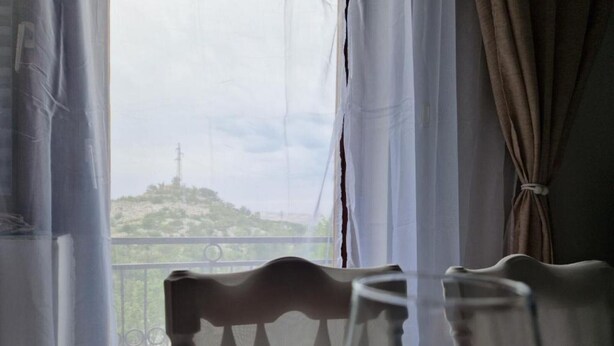 A room with a view of a hill and a power line. - Three Bedroom Apartment With Balcony And Sea View (Karlobag)