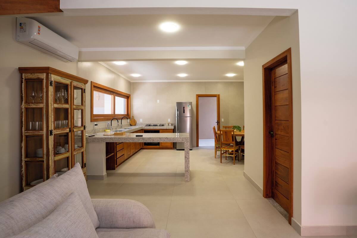 A kitchen with a dining area, a built-in oven, and a refrigerator.