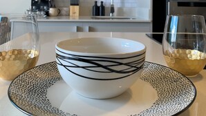 A modern kitchen with white cabinets, a microwave, and a refrigerator. - Executive studio close to National Stadium and AirPort (Rohrmoser)
