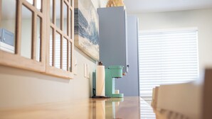 A kitchen with a wooden countertop, a coffee machine, and a window with blinds. - Anchor Point at Oak Shores! 5-min walk to beach (Biloxi)
