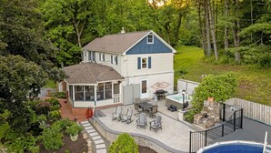 A two-story house with a patio, outdoor seating, a hot tub, and a swimming pool. - Pool | Hot Tub | 3 Min to Lake | Pets Allowed (Auburn)