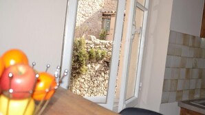 Una cocina con pared de piedra y ventana.