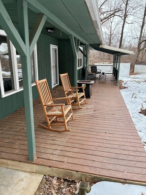 A covered wooden deck with rocking chairs and a grill area. - Newly Renovated 3BR : Quartz Kitchen : Fast Fiber WiFi : Carport Parking (Campbell)
