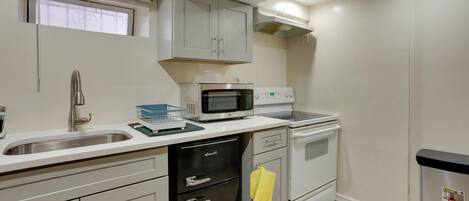 A compact kitchen with a microwave, oven, and dishwasher.