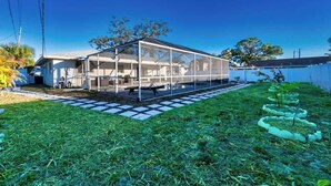 Une maison moderne dotée d’une grande serre à structure de verre.