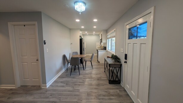 A hallway with a dining area, a chandelier, and a view of the outside. - Charming 3-bedroom cottage by downtown Atlanta (Atlanta)