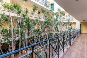 A multi-level atrium with a tiled floor and metal railings. - Tropical Holiday Apartment (Los Cristianos)