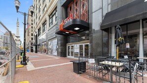 A street view of a building with a black awning and a sign that reads "A".