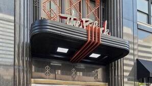 A building with a marquee sign reading "The Block" and a sign below stating "Loft Style Living 1, 2, 3 Bedroom Apartments".