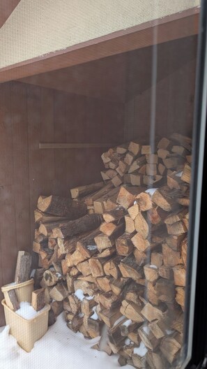 A wooden shed with a pile of firewood inside. - Family friendly 3 bedroom condo minutes from Mount Snow. (Dover)