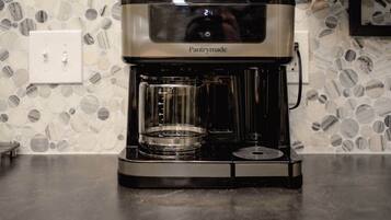 A Pantrymade coffee maker on a countertop with a mosaic tile backsplash.
