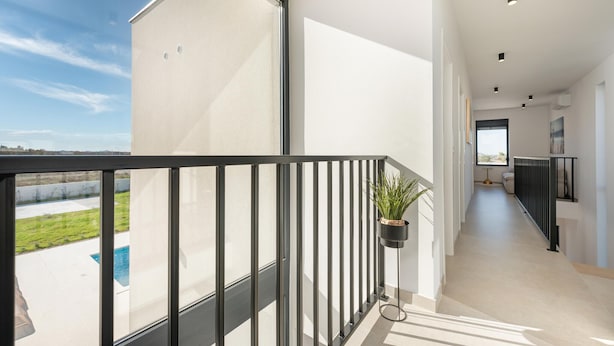 A modern apartment with a balcony, a view of a swimming pool, and a hallway leading to a bedroom. - Luxurious home in Policnik (Policnik)