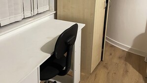 A room with a white desk, black office chair, and a wooden wardrobe. - City Centre Sunniside Sunderland (Sunderland)