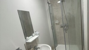 A bathroom with a glass-enclosed shower, a sink, and a mirror. - City Centre Sunniside Sunderland (Sunderland)