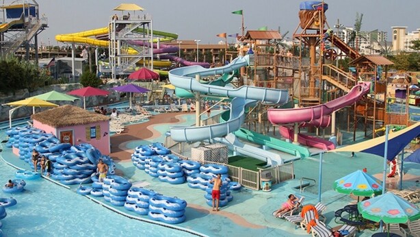 A water park with multiple slides and inflatable rafts. - BayCation Walk to Jolly Roger + Beach (Ocean City)