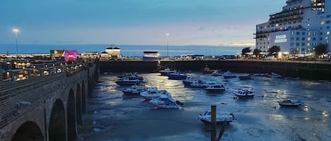 A waterfront area with a bridge, boats, and a hotel named 'Grand Budapest.'