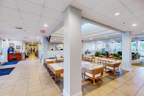 A spacious lobby with a long reception desk, comfortable seating areas, and a view of the outdoors through large windows. - 3rd floor condo w/ sauna, near theme parks, gym, shared pools, restaurant (Davenport)
