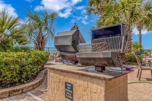 A barbecue grill area with a sign prohibiting personal grills. - Pinnacle 1471 Oceanfront Tower (Myrtle Beach)
