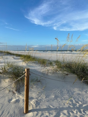 A sandy beach with a wooden post and a rope fence, leading to the ocean. - St Augustine Beach & Tennis Resort 507 (St. Augustine)