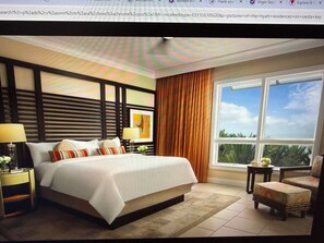 A hotel room with a large bed, a nightstand, a chair, and a window with a view of palm trees. - Hyatt Resort Siesta Key July 4th 3br/3ba 2255sqft Balcony over beach! Sleeps 6/8 (Sarasota)