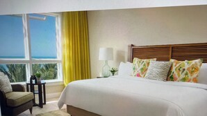A two-bedroom hotel room with a large bed, a view of the ocean, a small table with a plant, and a sofa. - Hyatt Resort Siesta Key July 4th 3br/3ba 2255sqft Balcony over beach! Sleeps 6/8 (Sarasota)