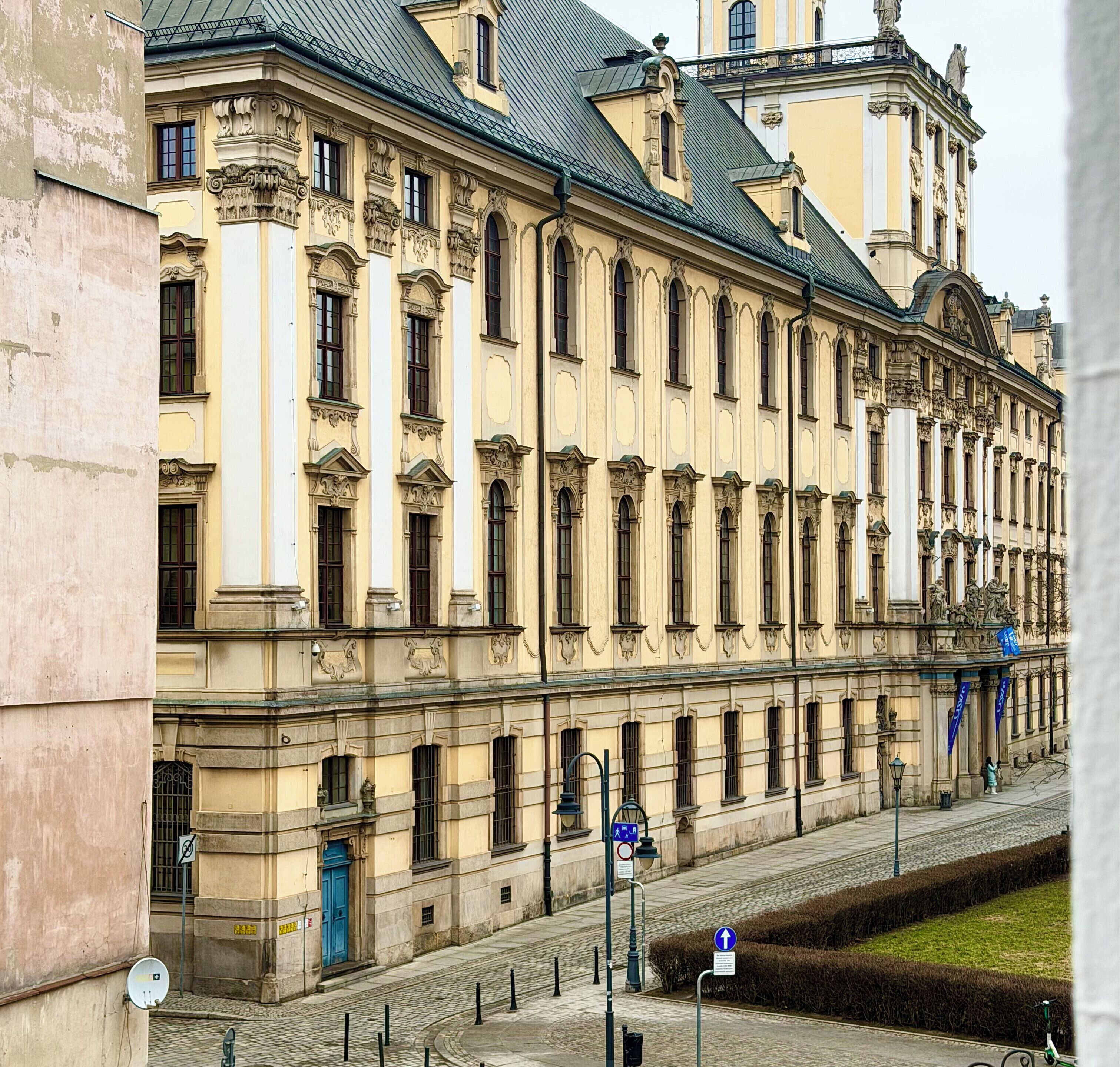 A historic building with classical architecture, featuring a symmetrical facade, large windows, and ornate details.