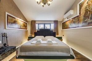 A hotel room with a large bed, two paintings on the walls, a chandelier, and a window with curtains. - Miracle No 8 Central Modern Duplex (Tirana)