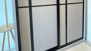 A room with a sliding door, a small table, and a chair. - Kuching Holiday Family Home @ Riverine Kuching (Kuching)