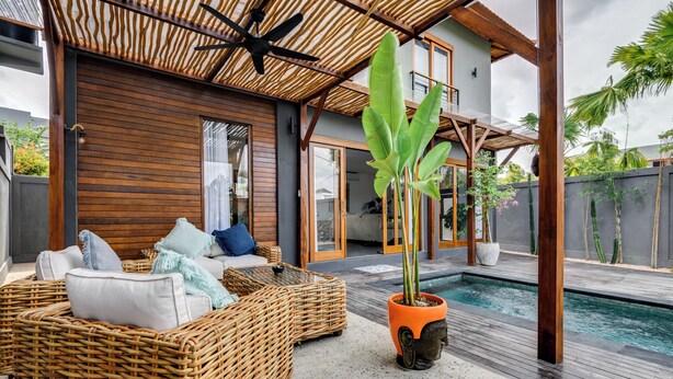 A modern outdoor living area with wicker furniture, a pool, and a wooden structure. - 2 Zen Bali Villa Canggu (Canggu)
