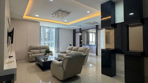 A modern living room with a sofa set, a coffee table, and recessed ceiling lighting. - Kuching Riverine Elegant Suite (Kuching)