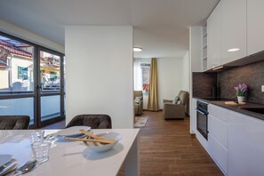 A modern kitchen with a dining area, large windows, and a view of the outside. - Luxury City Penthouse Adialuxe S7, Rijeka, Croatia (Rijeka)