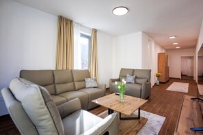 A modern living room with a sofa, armchair, and coffee table. - Luxury City Penthouse Adialuxe S7, Rijeka, Croatia (Rijeka)
