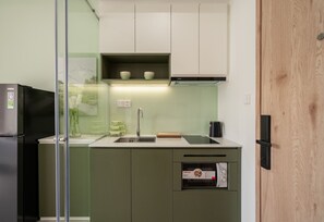 Standard Apartment | Private kitchen | Fridge, microwave, stovetop, cookware/dishes/utensils - CityHouse - Bellita (Tan Hung)
